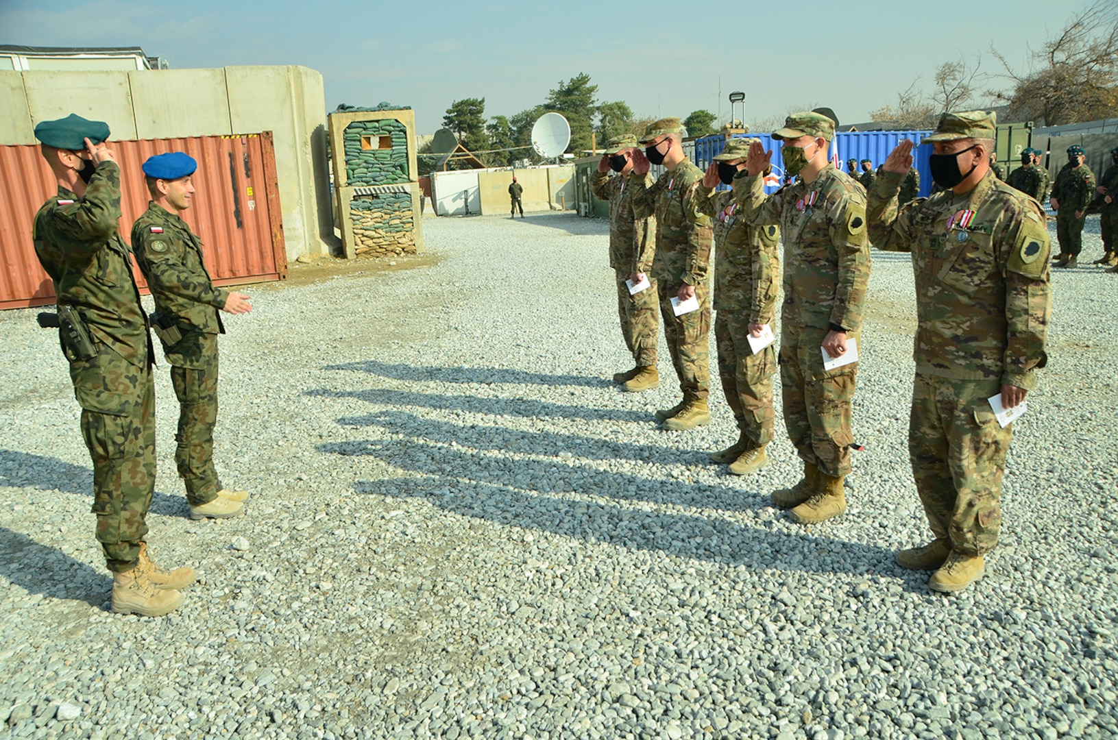 The Illinois Army National Guard Bilateral Embedded Support Team A25 render honors to members of the Polish military contingent during the ILARNG BEST decommissioning ceremony.