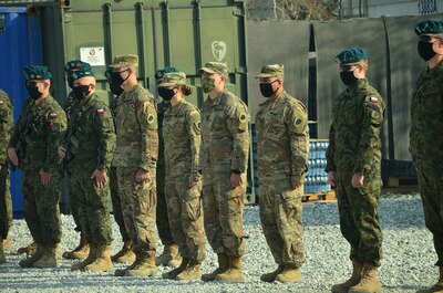 The Illinois Army National Guard Bilateral Embedded Support Team (BEST) A25 stand alongside the Polish military contingent during the ILARNG BEST decommissioning ceremony at Bagram Airfield, Afghanistan. Soldiers deployed with BEST A25 returned home Dec. 24.