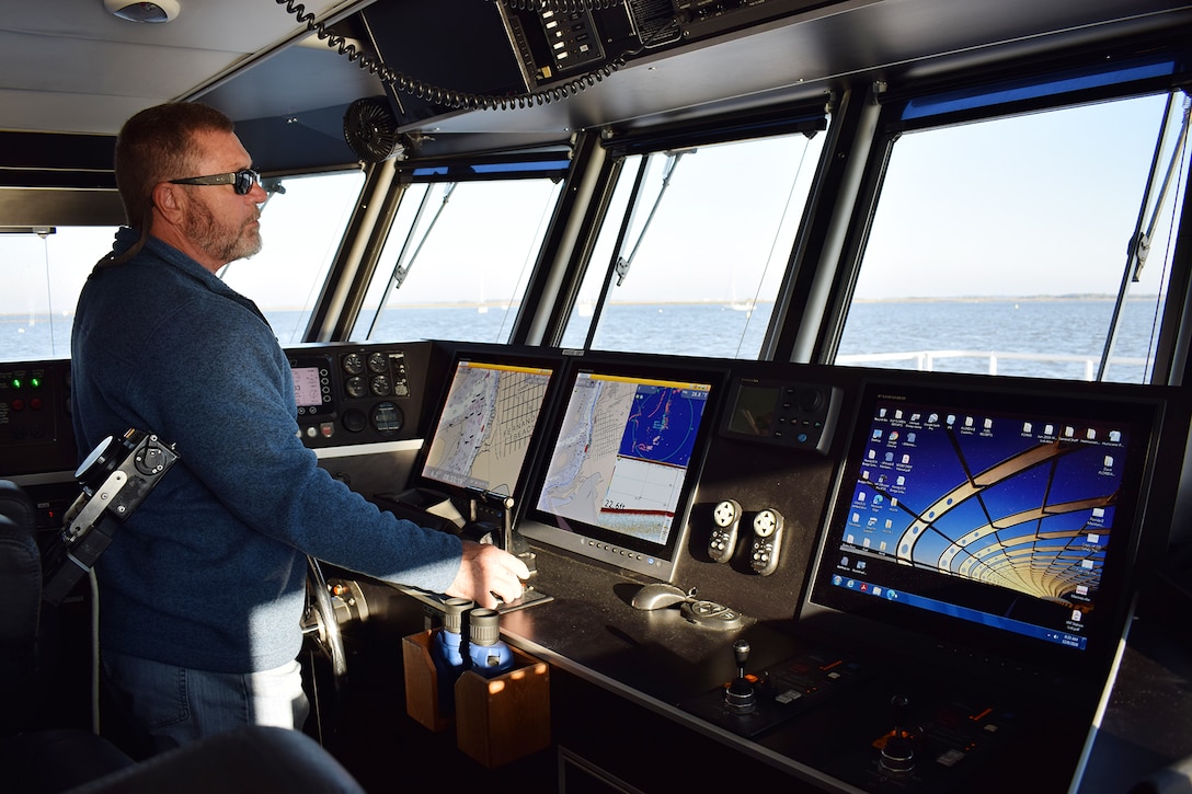 Tim Gregory, a captain onboard the U.S. Army Corps of Engineers, Jacksonville District Survey Vessel Florida II,
plots coarse across the seas during a routine hydrographic
survey