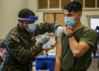A U.S. Marine with II MEF receives the COVID vaccine on Camp Lejeune, N.C., Jan. 20, 2021. Vaccination distribution prioritization within the DoD and the Marine Corps will be consistent with the data driven CDC guidance for national prioritization. Marines will continue to practice safety protocols to diminish the risk of COVID-19. (U.S. Marine Corps photo by Lance Cpl. Samuel Lyden)