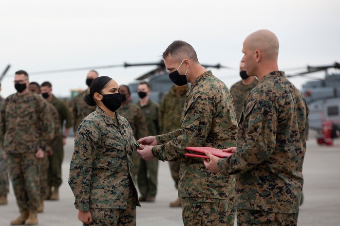 Lance Cpl. Alyssa David receives the Navy and Marine Corps Commendation Medal for heroic service during a ceremony at Marine Corps Air Station New River, North Carolina, January 22, 2021. David, a native of Bridgeport, Connecticut, serves as a maintenance administrative specialist at Marine Light Attack Helicopter Squadron 167. On the night of September 25, 2020, David came upon the scene of a vehicle collision where a tractor trailer struck a truck along Kinston Highway in Jacksonville, North Carolina. She immediately took charge of the scene, directed bystanders to call 911, and was able to triage and extract a toddler from the backseat of the vehicle. (U.S. Marine Corps photo by Lance Cpl. Yuritzy Gomez)