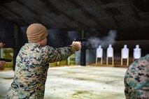 U.S. Marine Corps Staff Sgt. Hector De Jesus, a research and analytics chief with II Marine Expeditionary Force Communication Strategy and Operations, fires his M9 service pistol during a pistol range at Camp Lejeune, N.C., Feb. 3, 2021. Marines must have the versatility, flexibility, and skills to deal with any situation at any level of intensity across the entire range of military operations. (U.S. Marine Corps photo by Lance Cpl. Cheyenne Stillion)