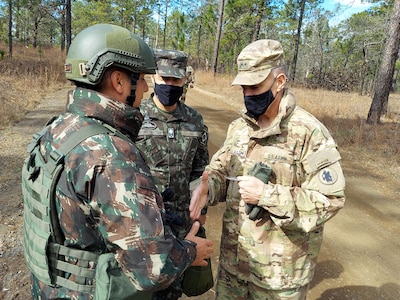 Maj. Gen. Daniel R. Walrath, right, U.S. Army South commanding general, greets a Brazilian Army soldier taking part in the bilateral training exercise at the Joint Readiness Training Center at Fort Polk, La., Feb. 2, as Lt. Gen. Lt. Gen. Marcos de Sá Affonso da Costa, chief of training, Land Forces Training Command, Exército Brasileiro, looks on.