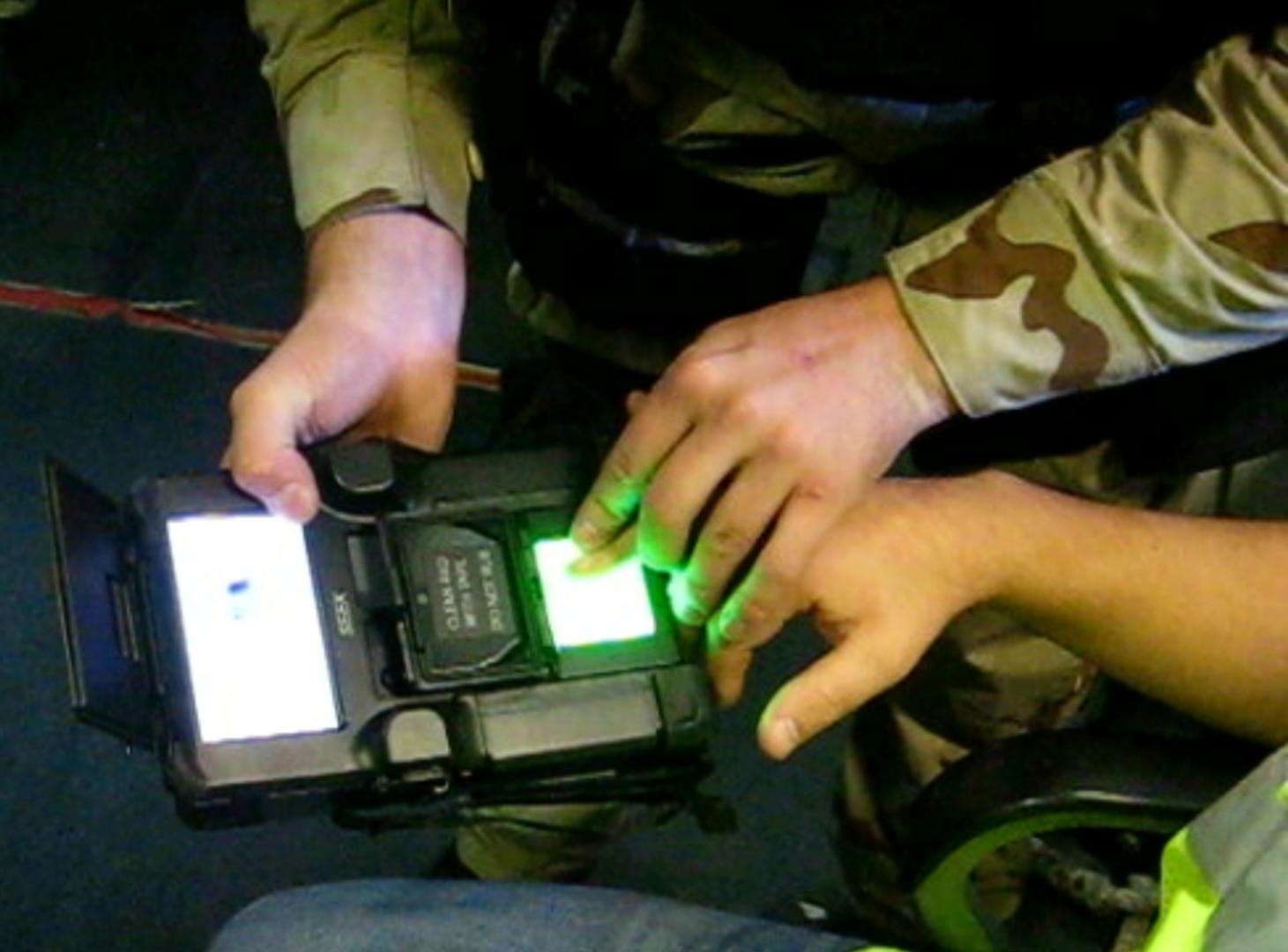 IMAGE: NORFOLK, Va. – A Sailor from a Navy visit, board, search and seizure team is collecting a subject’s biometrics via fingerprints for possible subject identification in the Identity Dominance System (IDS). The system – to be upgraded with a Naval Surface Warfare Center Dahlgren Division (NSWCDD)-developed IDS technology refresh in fiscal year 2021 – collects biometrics such as face, finger, and iris images, and enrolls that information into a local database to match against known persons of interest. Once the information has been captured, the system sends the information back to the authoritative database. Since the outbreak of COVID-19, NSWCDD scientists and engineers transitioned to telework while developing software in support of a complete technology refresh focused on modifying the IDS form factor to be smaller and lighter with an enhanced system performance that increases computing power, speed, local matching and communications capabilities.  (U.S. Navy photo/Released)