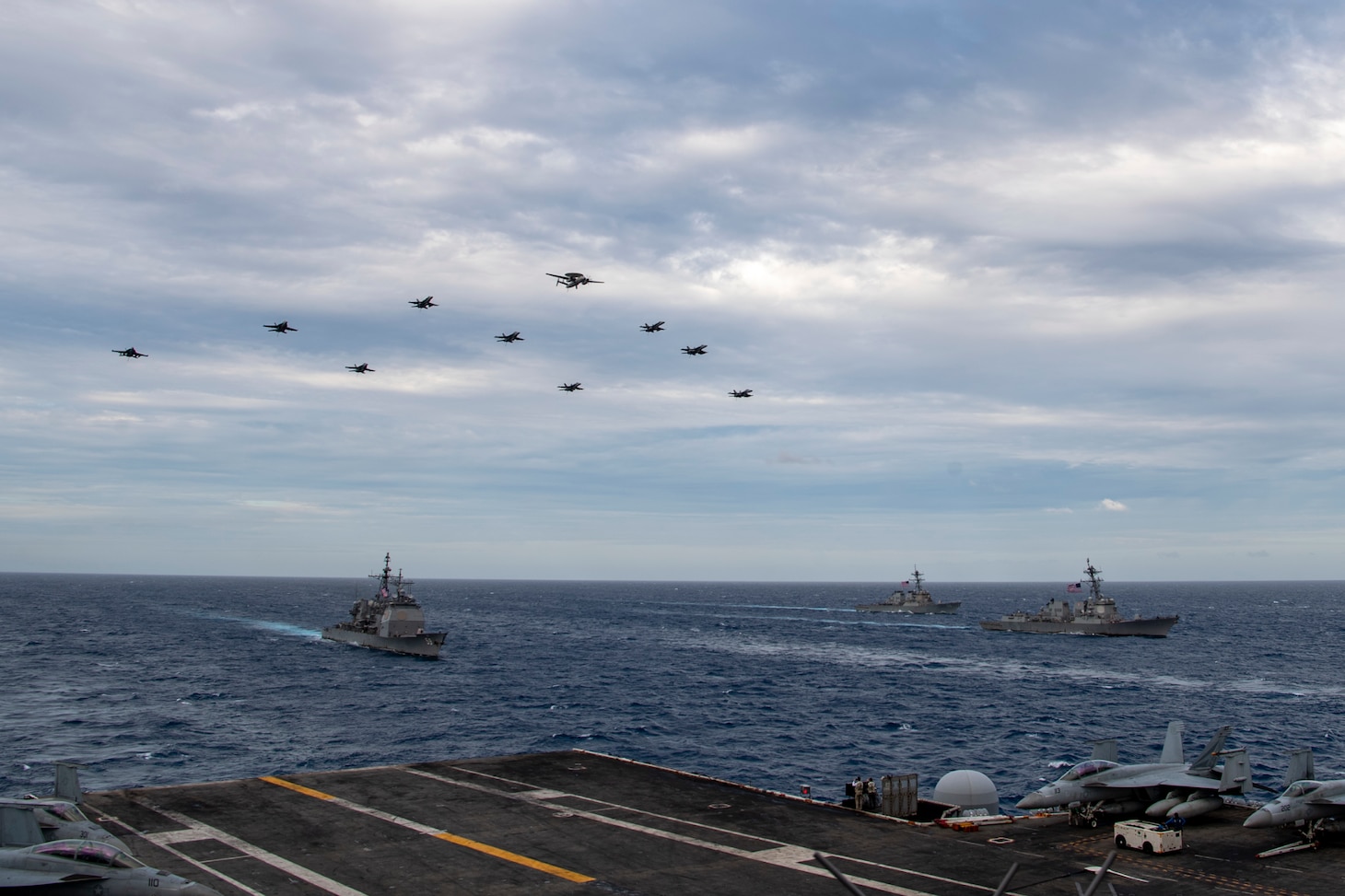 SOUTH CHINA SEA (Feb. 9, 2021) – Aircraft assigned to Carrier Air Wing (CVW) 17 fly over the Theodore Roosevelt Carrier Strike Group and the Nimitz Carrier Strike Group in the South China Sea Feb. 9, 2021. The Theodore Roosevelt and Nimitz Carrier Strike Groups are conducting dual-carrier operations during their deployments to the 7th Fleet area of operations. As the U.S. Navy's largest forward-deployed fleet, 7th Fleet routinely operates and interacts with 35 maritime nations while conducting missions to preserve and protect a free and open Indo-Pacific Region. (U.S. Navy photo by Mass Communication Specialist Seaman Deirdre Marsac)