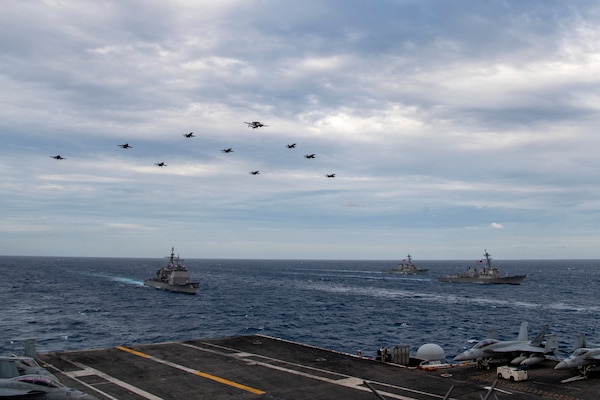 Aircraft assigned to Carrier Air Wing (CVW) 17 fly over the Theodore Roosevelt Carrier Strike Group and the Nimitz Carrier Strike Group in the South China Sea.