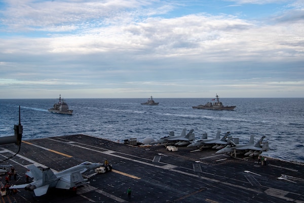 The Theodore Roosevelt Carrier Strike Group transits in formation with the Nimitz Carrier Strike Group in the South China Sea.