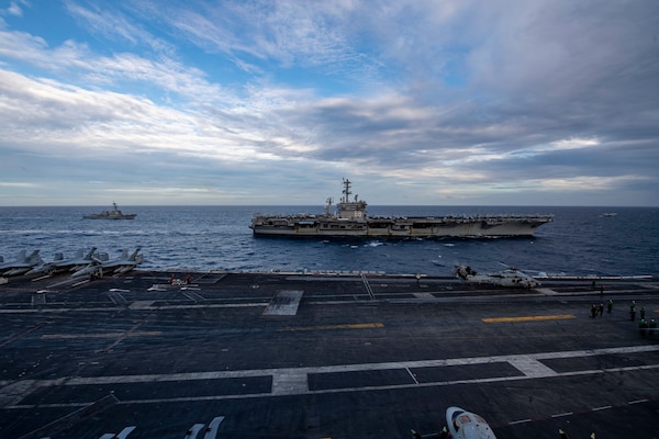 The Theodore Roosevelt Carrier Strike Group transits in formation with the Nimitz Carrier Strike Group in the South China Sea.