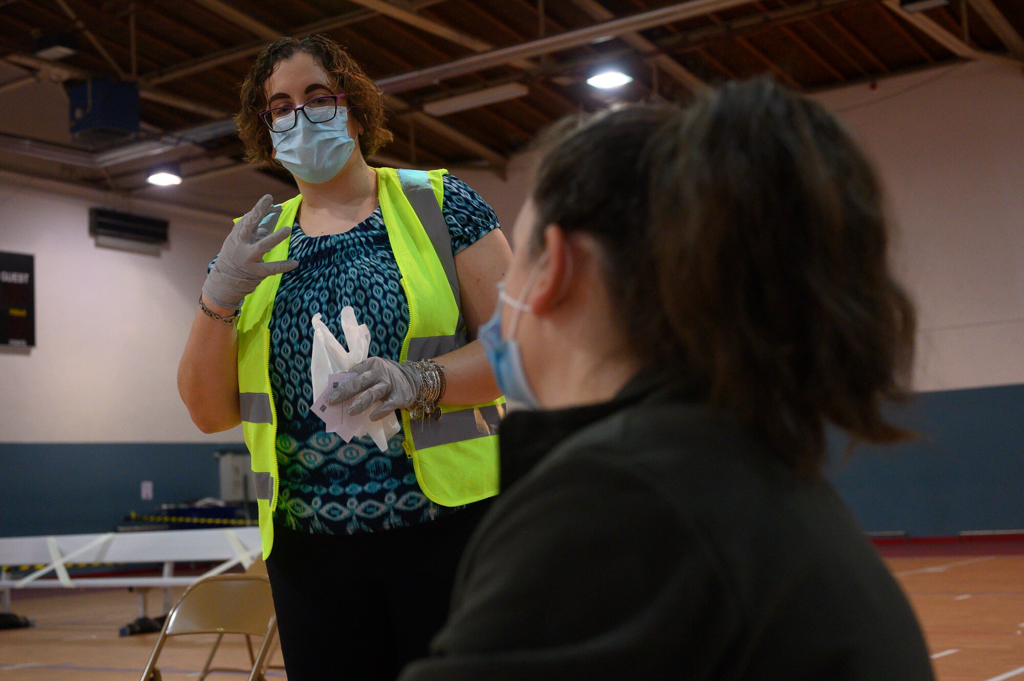 A photo of a volunteer speaking with a patient.