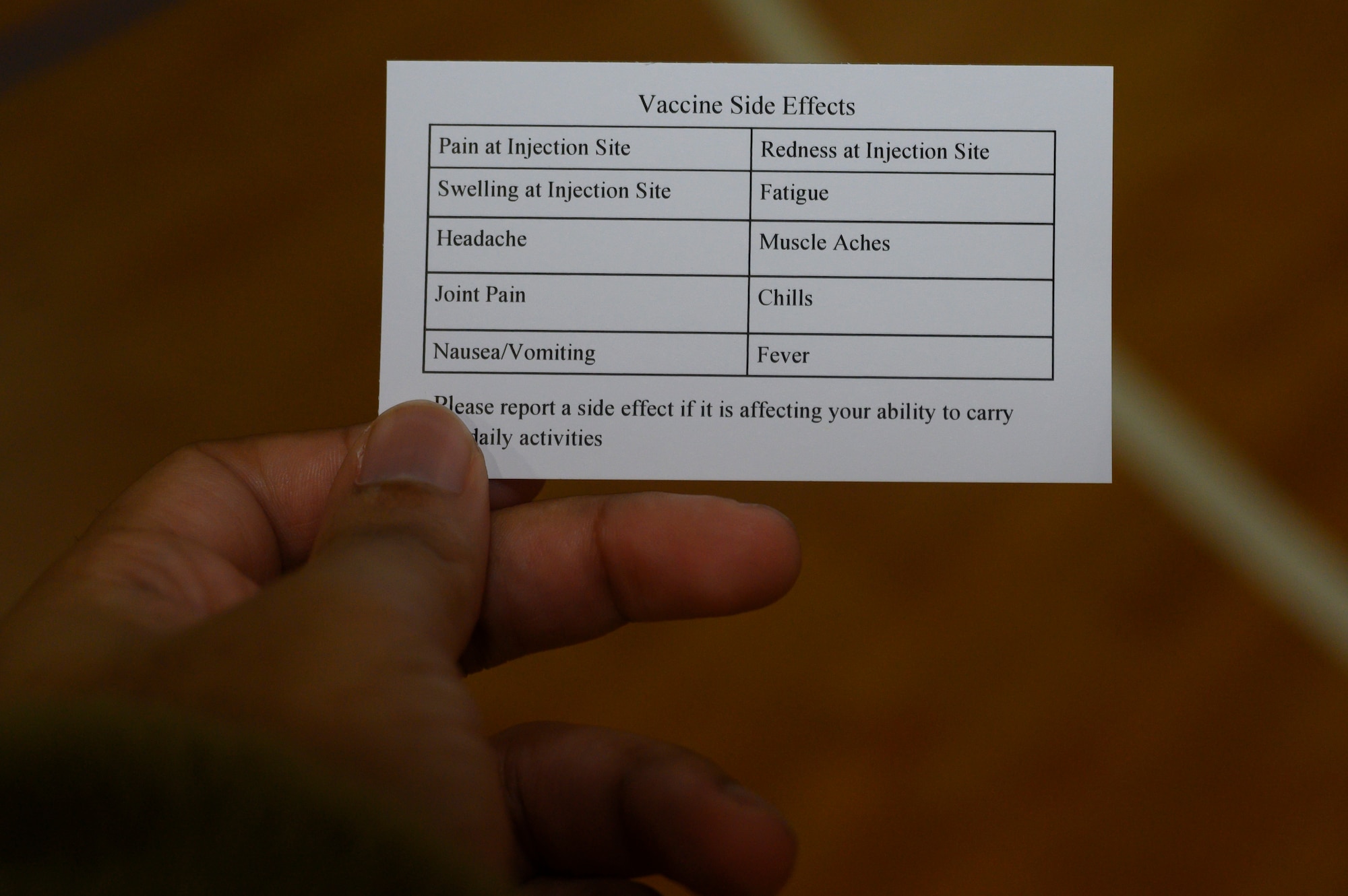 A card listing common COVID-19 vaccine side effects.