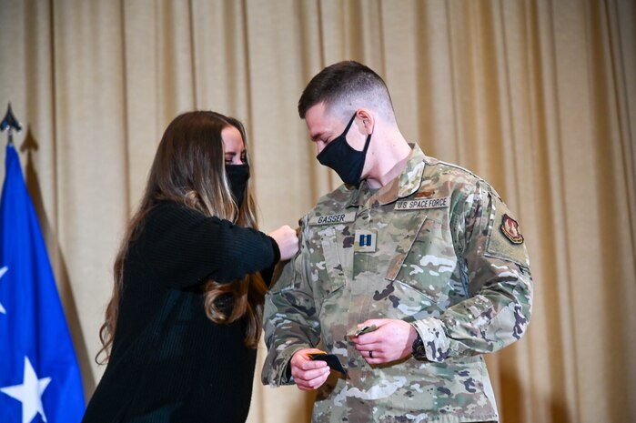 Captain Joshua Gasser, Minuteman III Directorate, gets his patches replaced by his wife, Megan.
