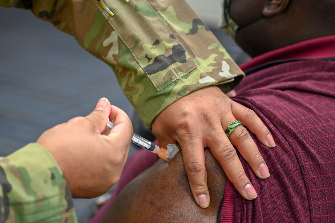 A man receives the COVID-19 vaccine
