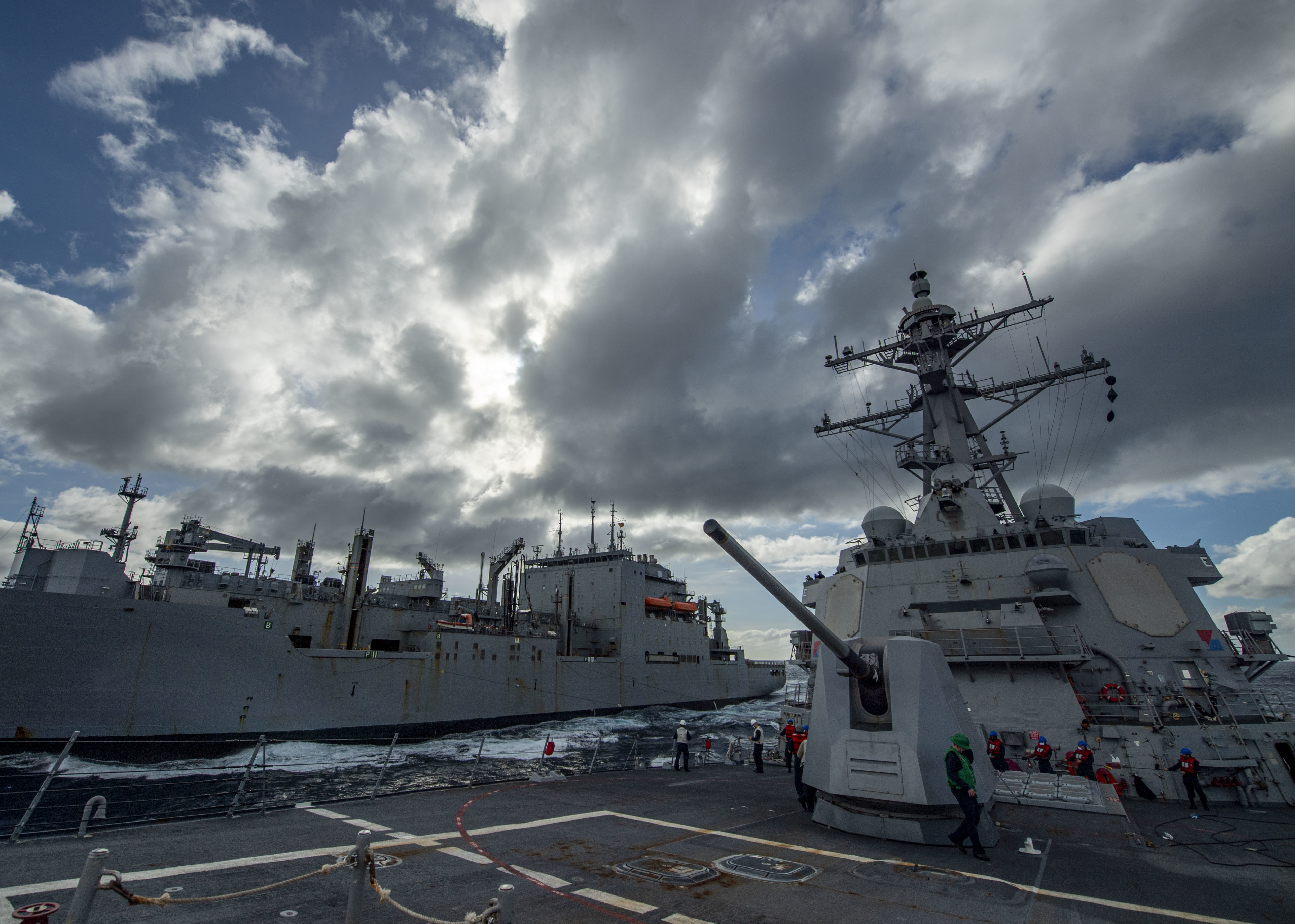 The Arleigh Burke-class guided-missile destroyer USS John Finn (DDG 113), front, transits alongside the Military Sealift Command dry cargo and ammunition ship USNS Matthew Perry (T-AKE 9) during a replenishment-at-sea Feb. 4, 2021.