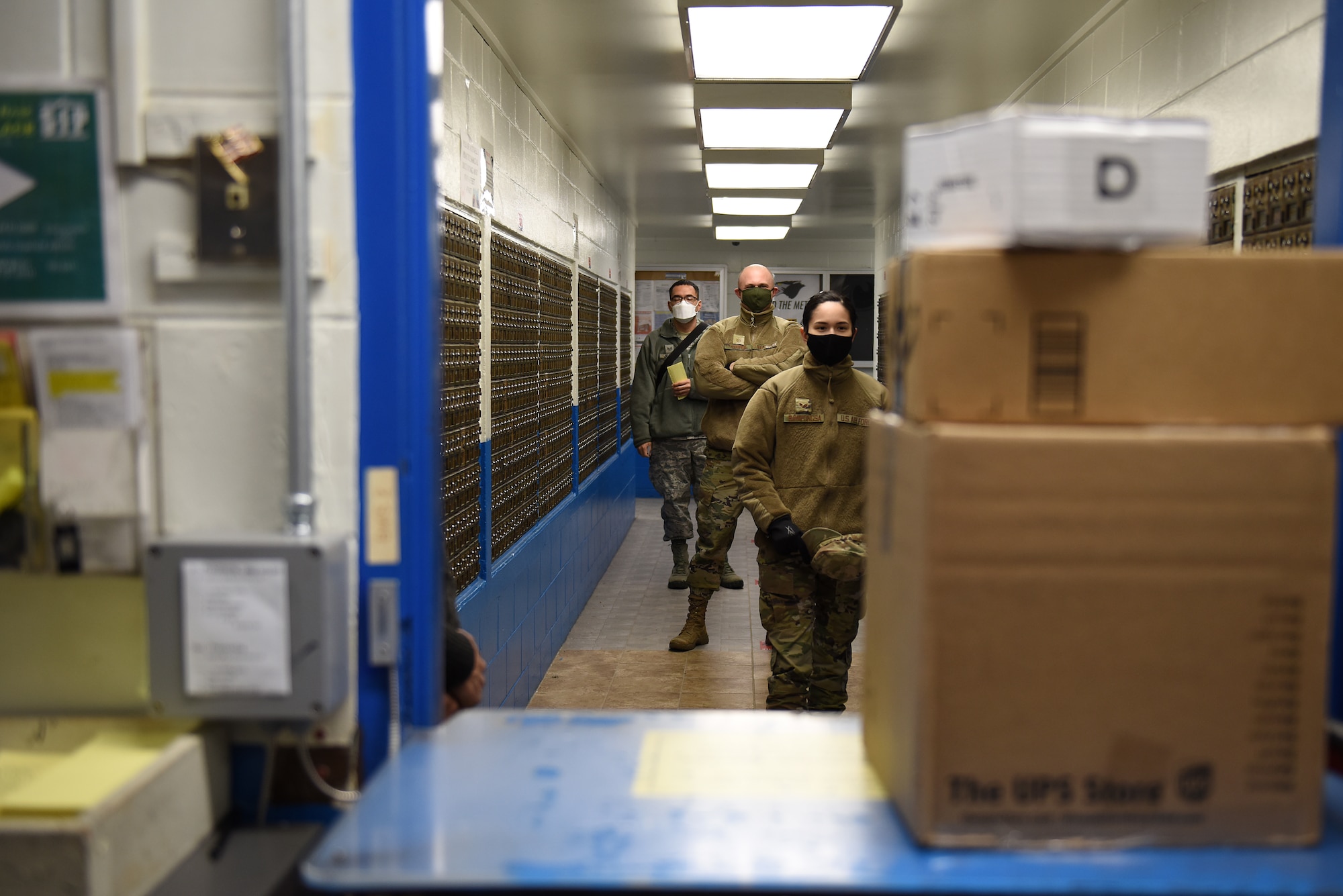 Airmen wait in line at the post office to pick up packages at Kunsan Air Base, Republic of Korea, Feb. 3, 2021. The post office receives and distributes approximately 5,000 packages a week to the members of Kunsan.