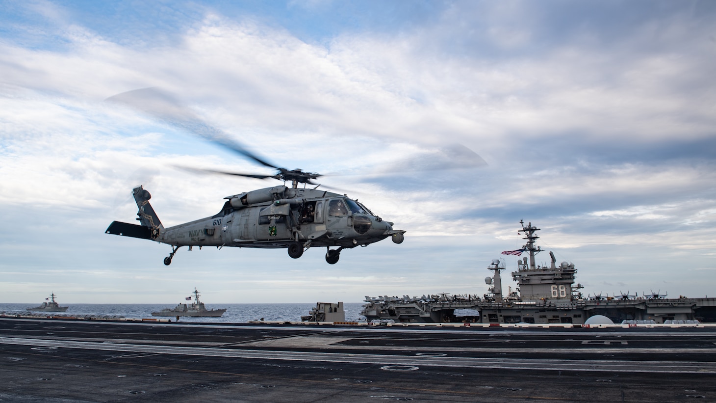 SOUTH CHINA SEA (Feb. 9, 2021) An MH-60S Sea Hawk, assigned to the “Eightballers” of Helicopter Sea Combat Squadron (HSC) 8, lands on the flight deck of the aircraft carrier USS Theodore Roosevelt (CVN 71) while the ship transits in formation with the Nimitz Carrier Strike Group in the South China Sea Feb. 9, 2021. The Theodore Roosevelt and Nimitz Carrier Strike Groups are conducting dual-carrier operations during their deployments to the 7th Fleet area of operations. As the U.S. Navy’s largest forward-deployed fleet, 7th Fleet routinely operates and interacts with 35 maritime nations while conducting missions to preserve and protect a free and open Indo-Pacific region. (U.S. Navy photo by Mass Communication Specialist 2nd Class Zachary Wheeler)