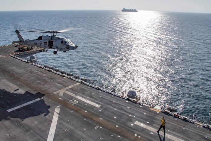 A MH-60R Sea Hawk helicopter, attached to Helicopter Maritime Strike Squadron (HSM) 49, departs the flight deck of amphibious assault ship USS Makin Island (LHD 8) as the ship transits the Strait of Hormuz, Feb. 8. The Makin Island Ready Group and the 15th Marine Expeditionary Unit are deployed to the U.S. 5th Fleet area of operations in support of naval operations to ensure maritime stability and security in the Central Region, connecting the Mediterranean and Pacific through the western Indian Ocean and three strategic choke points. (U.S. Marine Corps photo by Sgt. Sarah Stegall)