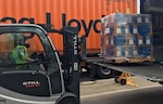 forklift operator moving a pallet of equipment