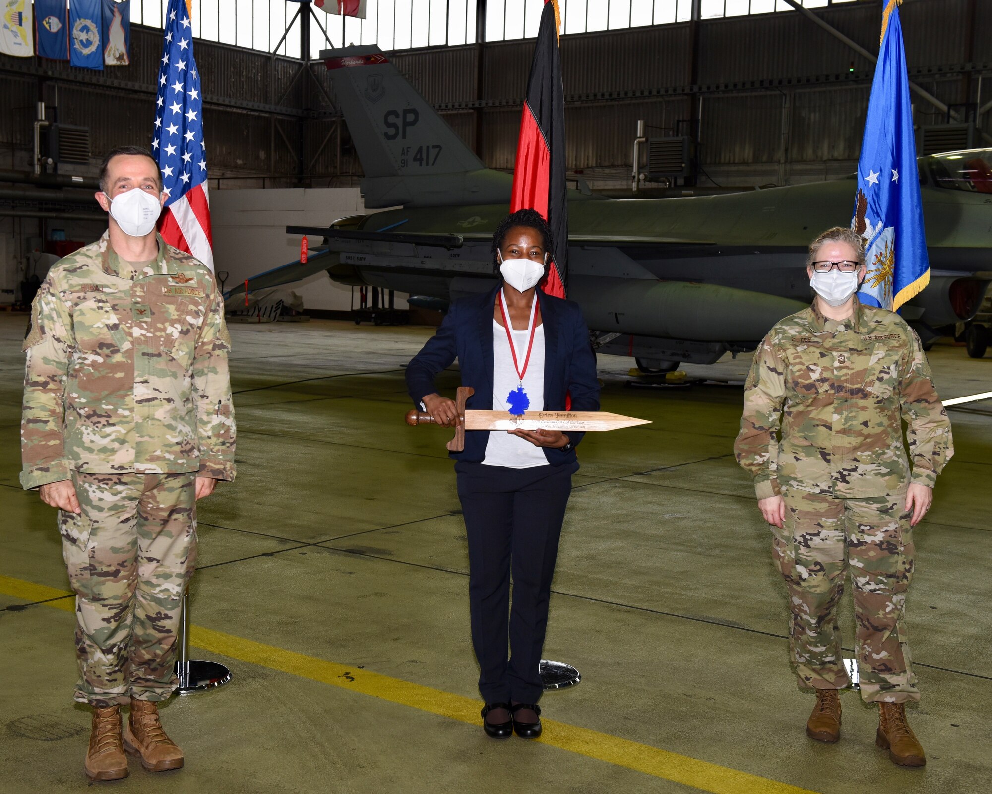 U.S. Air Force Col. Jason Hokaj, 52nd Fighter Wing vice commander (left), and Chief Master Sgt. Stephanie Cates, 52nd Fighter Wing command chief (right), give the Category One Civilian of the Year award to Erica Hamilton, 52nd Munitions Maintenance Group, Feb. 5, 2021, at Spangdahlem Air Base, Germany