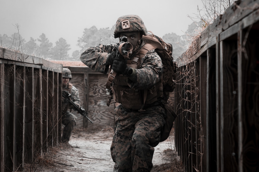 A U.S. Marine clears a simulated enemy cache site during a simulated live fire event on Camp Lejeune, N.C., Feb. 2.