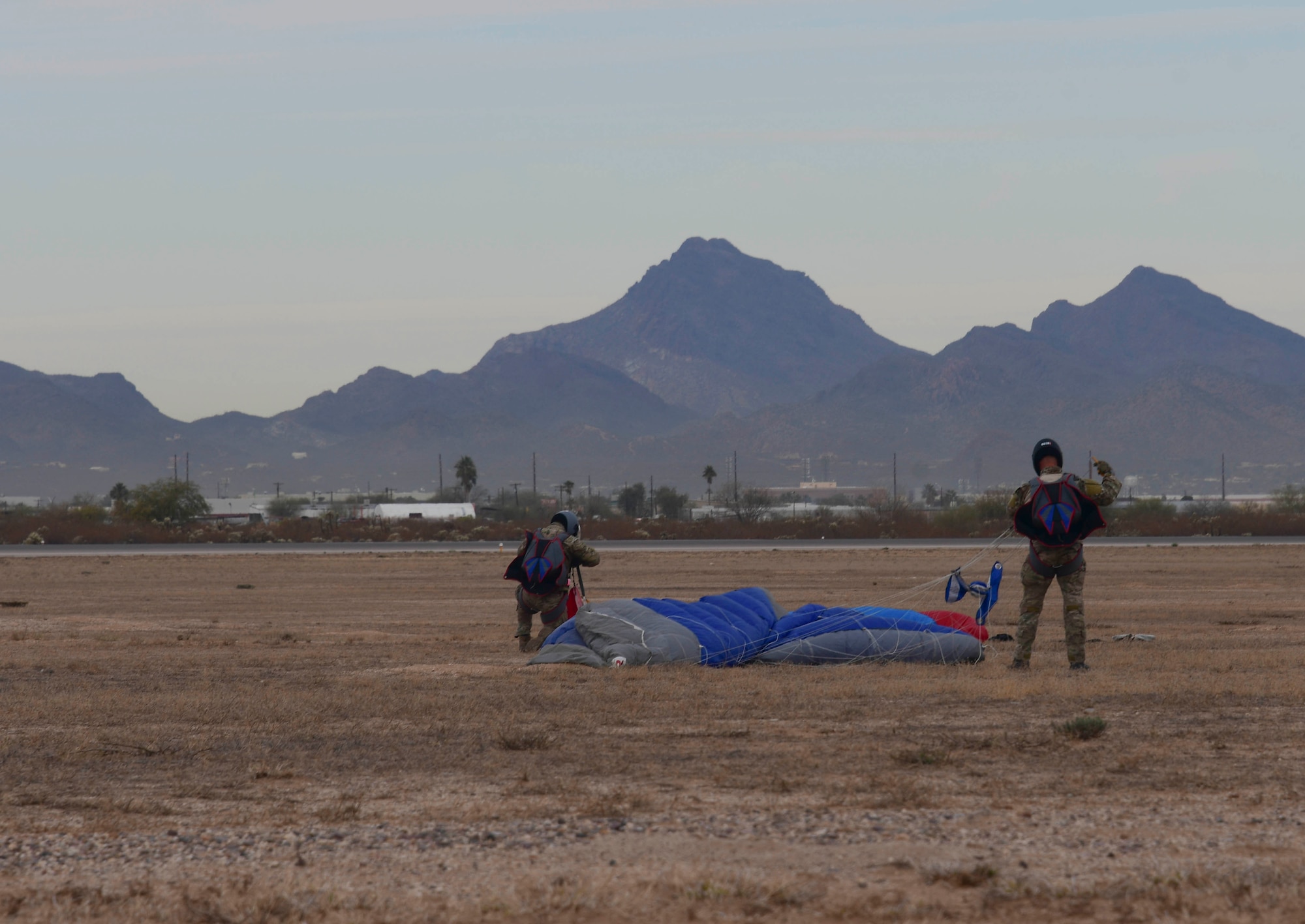 U.S. Air Force pararescuemen packing their parachutes