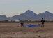 U.S. Air Force pararescuemen packing their parachutes