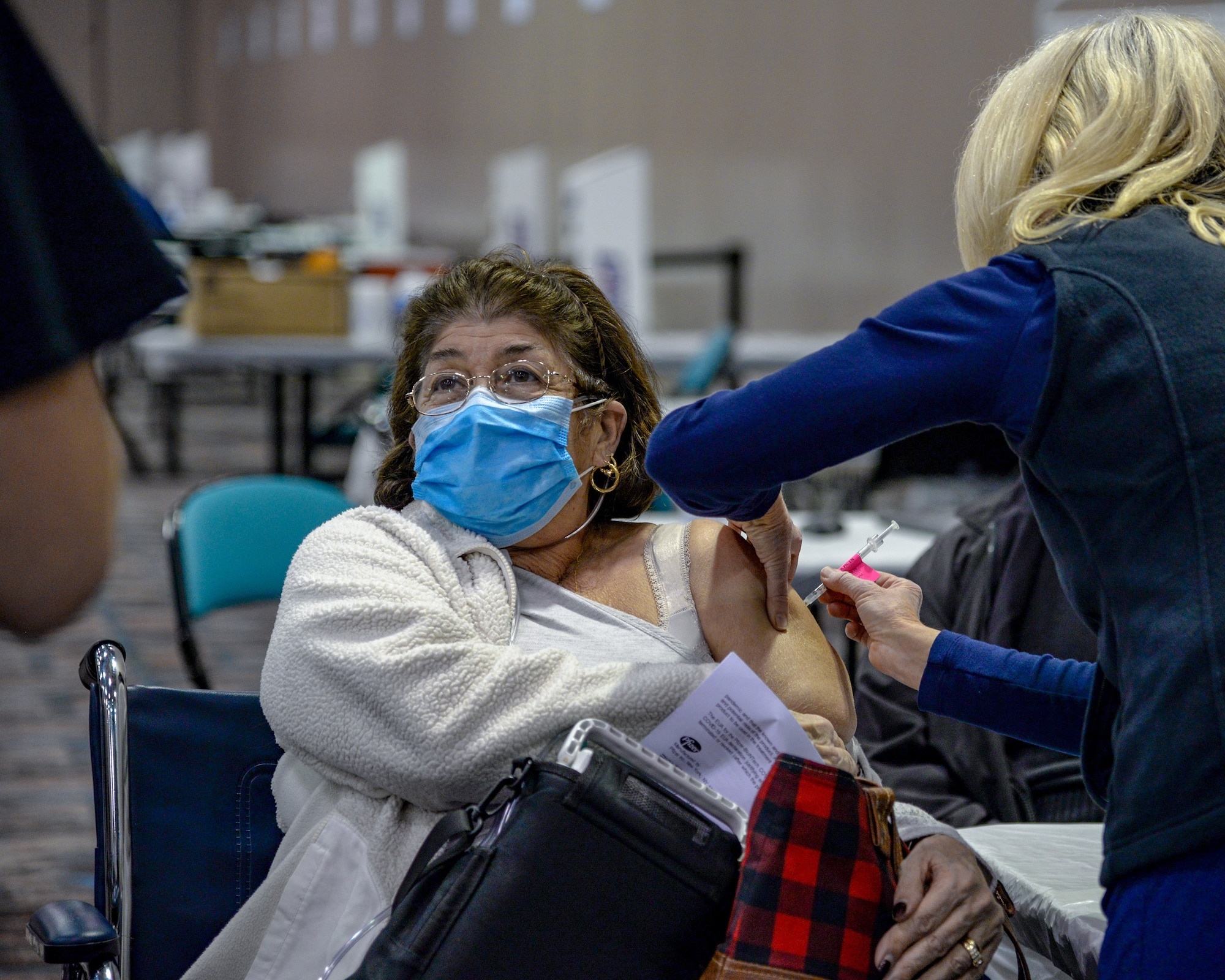 An image of NJ Air National Guard and AtlantiCare Regional Health Services members serving at the Atlantic City Convention Center, Atlantic City, N.J., to help the residents of New Jersey receive the COVID-19 vaccination at the Atlantic County Point Of Distribution mega-site.