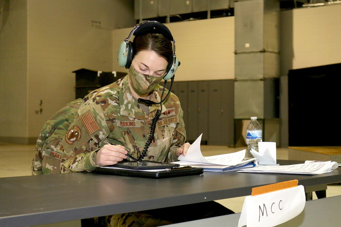 Capt. Emily Perkins, a flight nurse with the 445th Aeromedical Evacuation Squadron, checks information on her tablet during a mission brief Jan. 9, 2021.