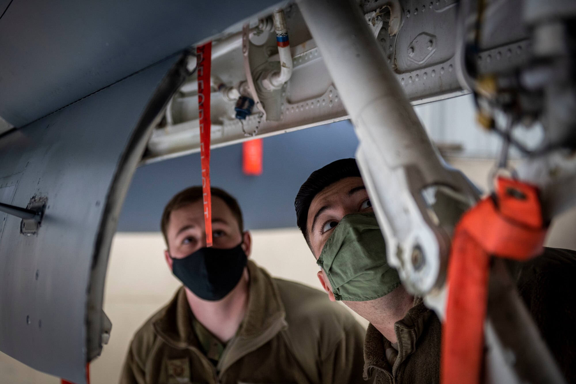 Staff Sgt. William Price (left) and Tech. Sgt. Jorge Gonzalez (right), 4th Fighter Readiness Squadron quality assurance inspectors, perform a safety inspection on an F-15E Strike Eagle at Seymour Johnson Air Force Base, North Carolina, Feb. 4, 2021.