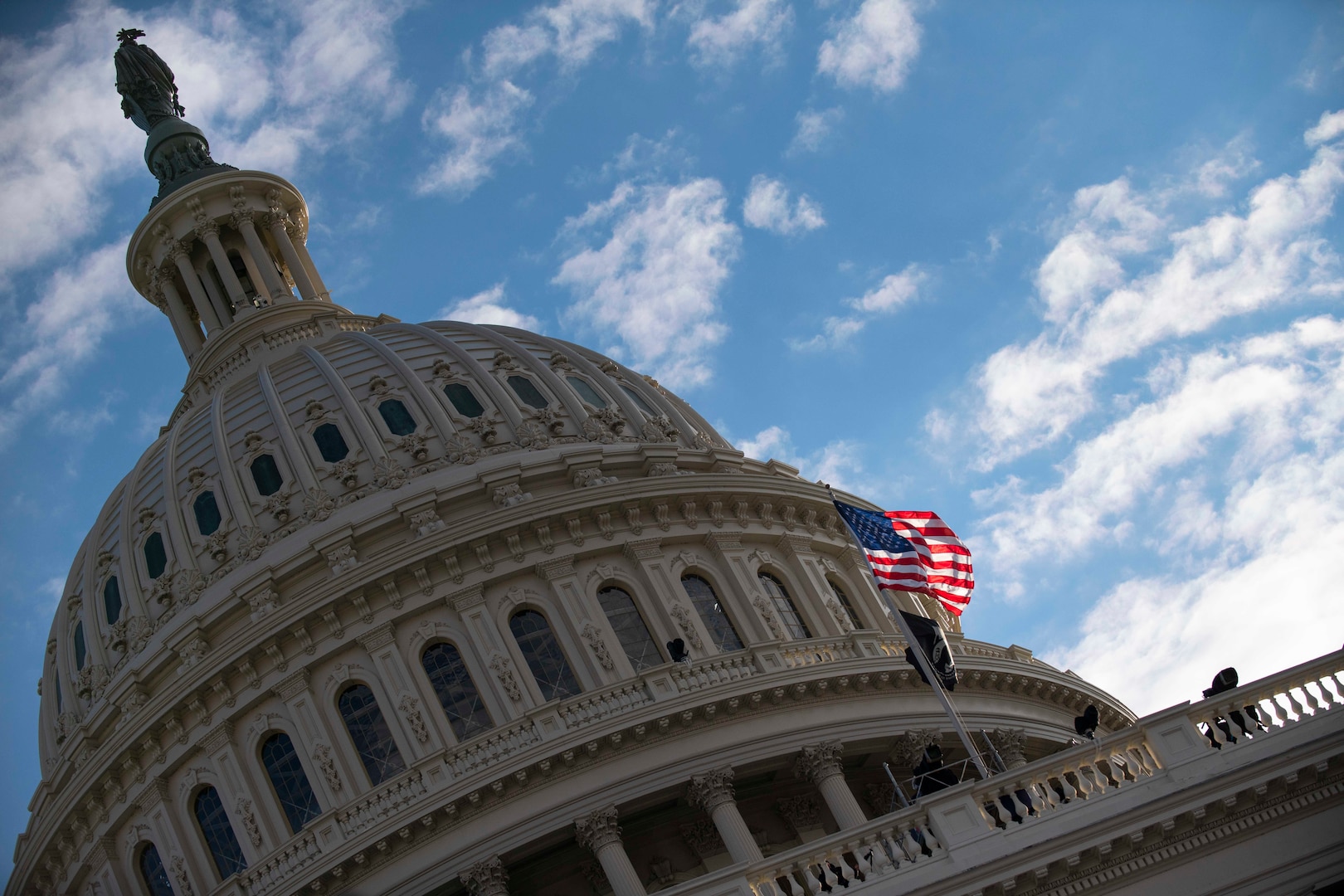 American flag flies outside Capitol Building during 59th Presidential Inauguration ceremony.