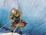 Sailor and multipurpose canine from Naval Special Warfare Group One practice crevasse self-recovery techniques during austere high-altitude environment training, at Knik Glacier, Alaska, September 11, 2020