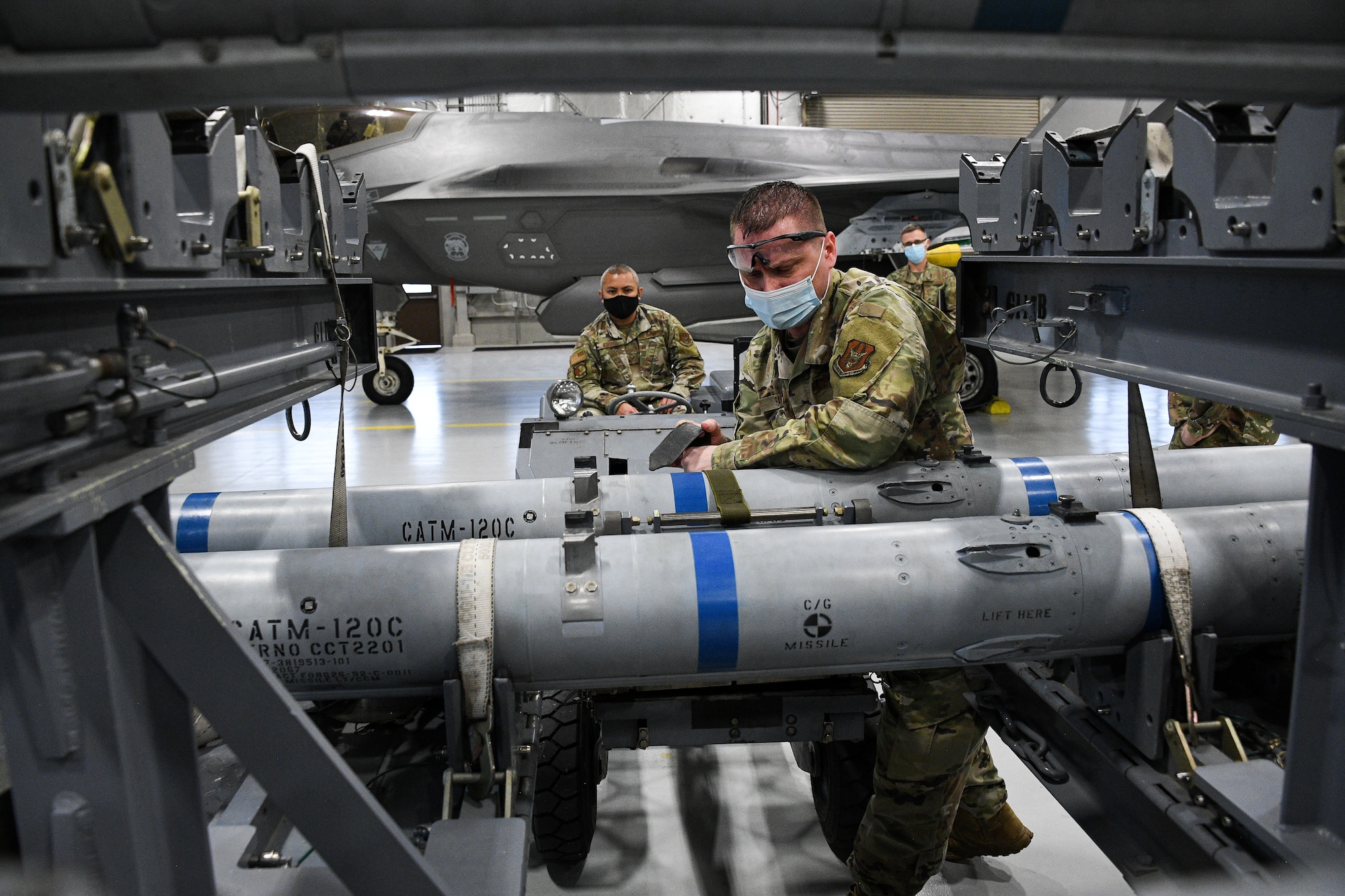 A photo of F-35 maintainers loading weapons