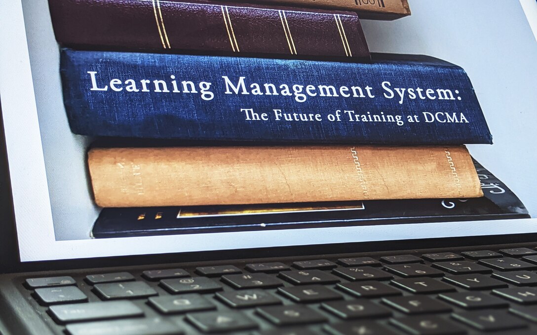 A computer screen shows books, one labeled Learning Management System