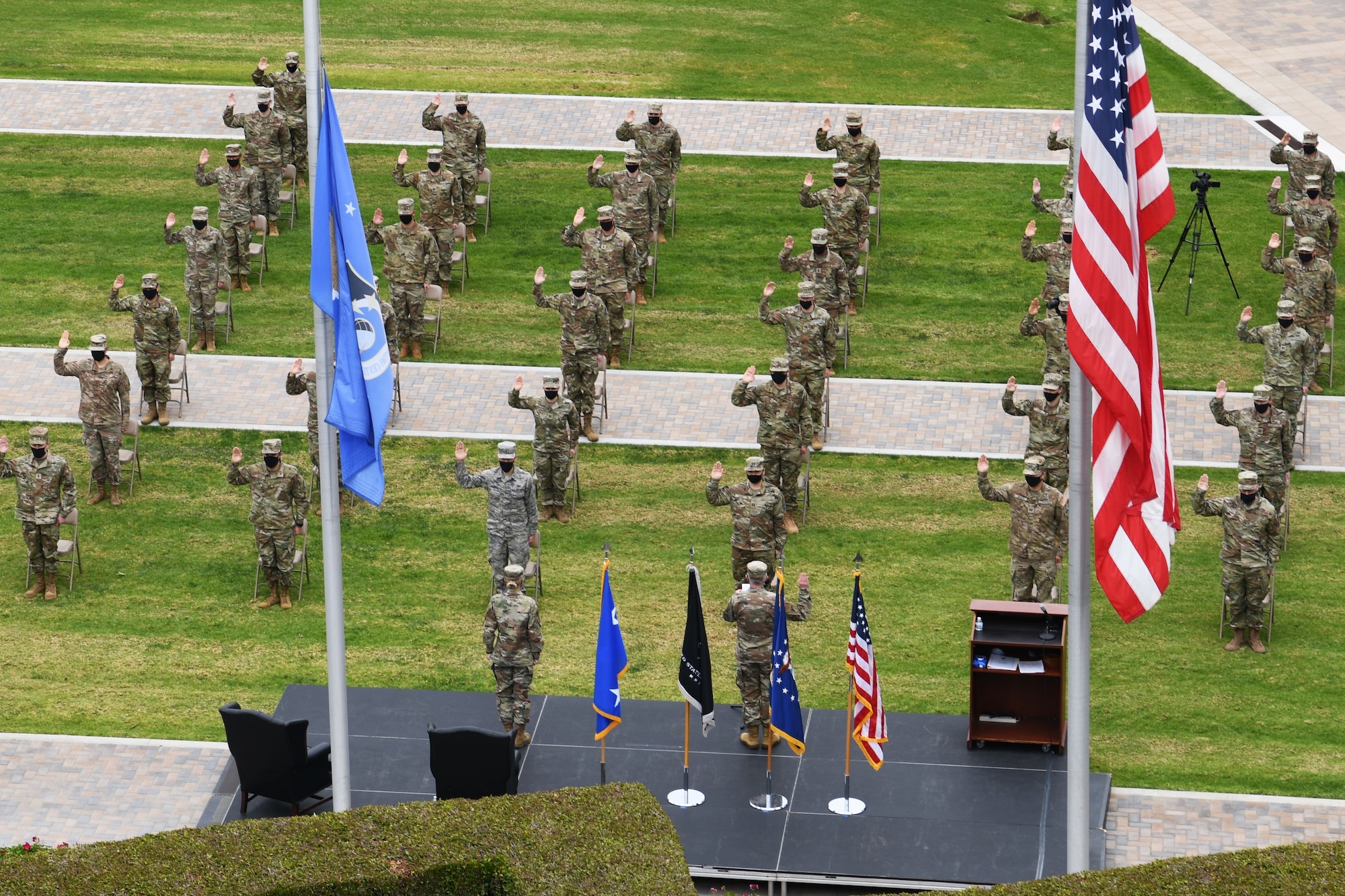 Airmen of the Space and Missile Systems Center and 61st Air Base Group participate in a U.S. Space Force transfer ceremony at Los Angeles Air Force Base, Calif., Feb. 9, 2021. U.S. Air Force Lt. Gen. John F. Thompson, SMC commander, was the key note speaker and presided over the Oath of Office and Oath of Enlistement which transfered a total of 113 personnel; 74 in person and 39 virtual. More than 2,400 members in space-related career fields around the globe will transition from the U.S. Air Force into the U.S. Space Force over the next several months. (U.S. Space Force photo by Staff Sgt. Luke Kitterman)