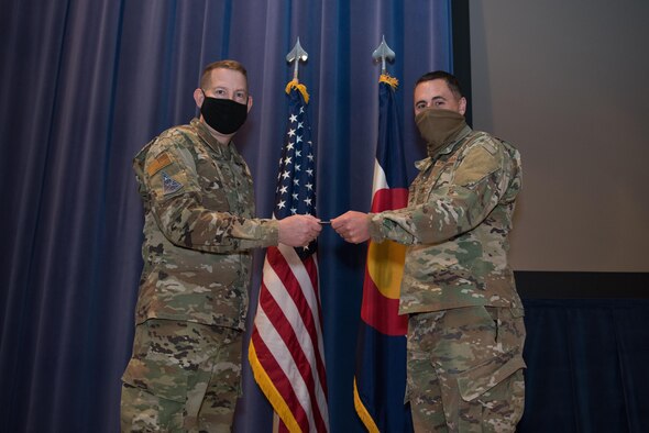 Man presenting coin to another man