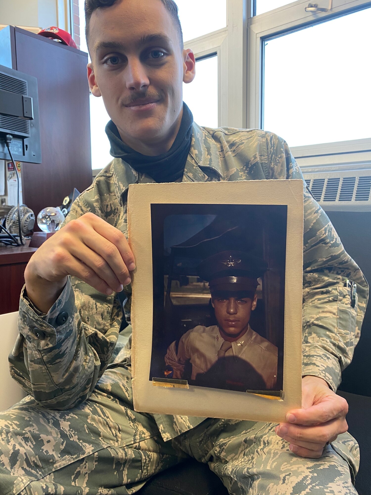 Airman 1st Class Stephen D. Gallwey, 270th Engineering Installation Squadron cable antenna technician, with a photo of his grandfather, 1st Lt. James H. Gallwey, an original Tuskegee Airmen pilot, Dec. 6, 2020, in Horsham, Pennsylvania. His grandfather’s legacy motivated his decision to join the Air National Guard.