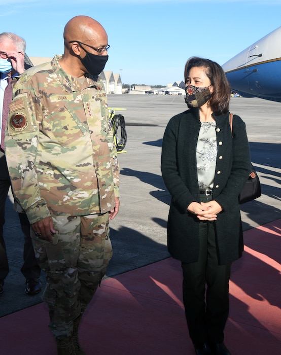 Photo shows man and woman walking away from aircraft.