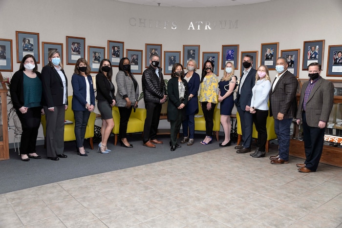 Photo shows a group of people lined up for a picture.