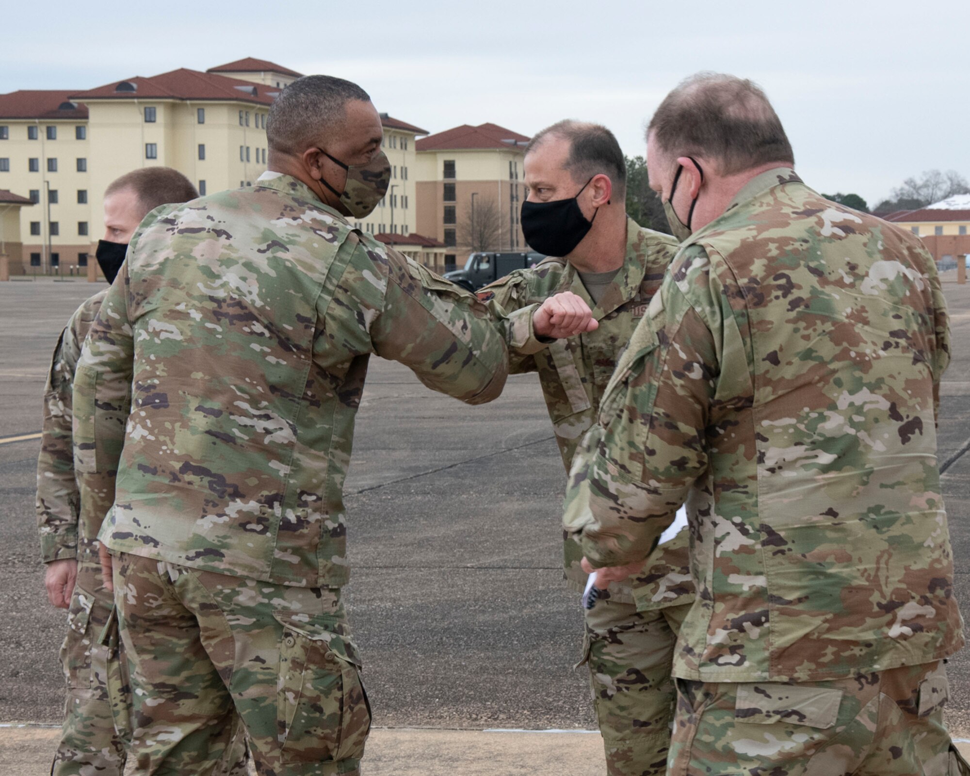 Chief Master Sgt. Timothy White (left), Air Force Reserve Command command chief, is greeted by Col. Craig Drescher (center), 908th Airlift Wing commander, with Lt. Gen. Richard Scobee (right)