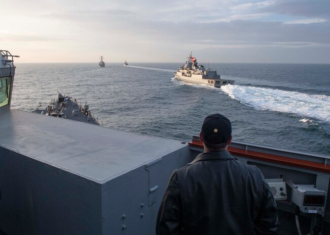 210209-N-RG171-0354 BLACK SEA (Feb. 9, 2021) Cmdr. Matthew Curnen, commanding officer of the Arleigh Burke-class guided-missile destroyer USS Donald Cook (DDG 75), watches as the Turkish navy Yavuz-class TCG Turgutreis (F-241), middle, and the Turkish navy Barbaros-class frigate TCG Orucreis (F-245), right, participate in a passing exercise with the Donald Cook and the Arleigh Burke-class guided-missile destroyer USS Porter (DDG 78) in the Black Sea, Feb. 9, 2021. Donald Cook, forward-deployed to Rota, Spain, is on patrol in U.S. Sixth Fleet in support of regional allies and partners and U.S. national security in Europe and Africa. (U.S. Navy photo by Mass Communication Specialist 3rd Class Will Hardy/Released)