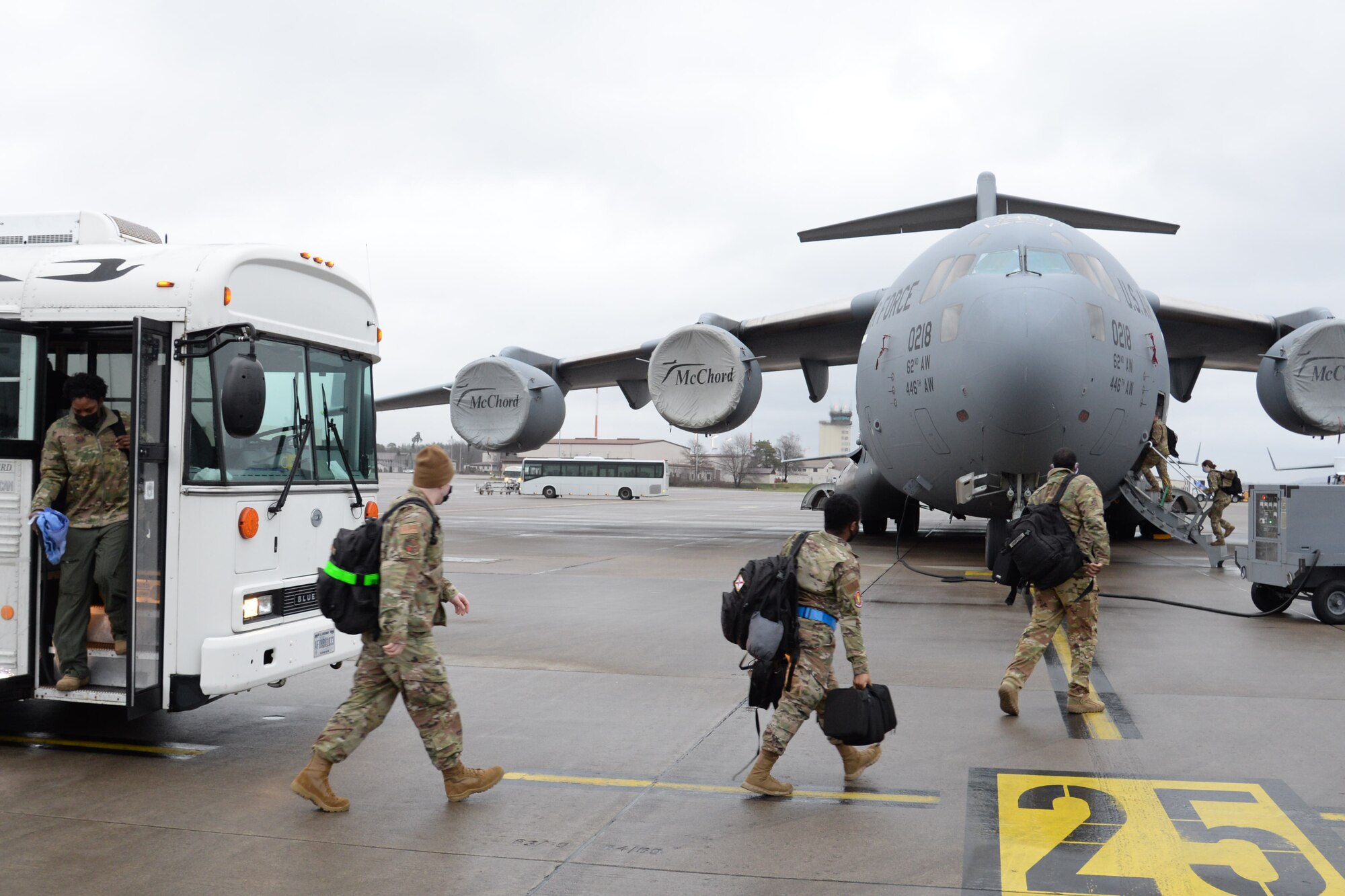 U.S. Air Force Airmen assigned to the 10th Expeditionary Aeromedical Evacuation Flight disembark from a bus and enter a C-17 Globemaster III aircraft for a training at Ramstein Air Base, Germany, Jan. 26, 2021.