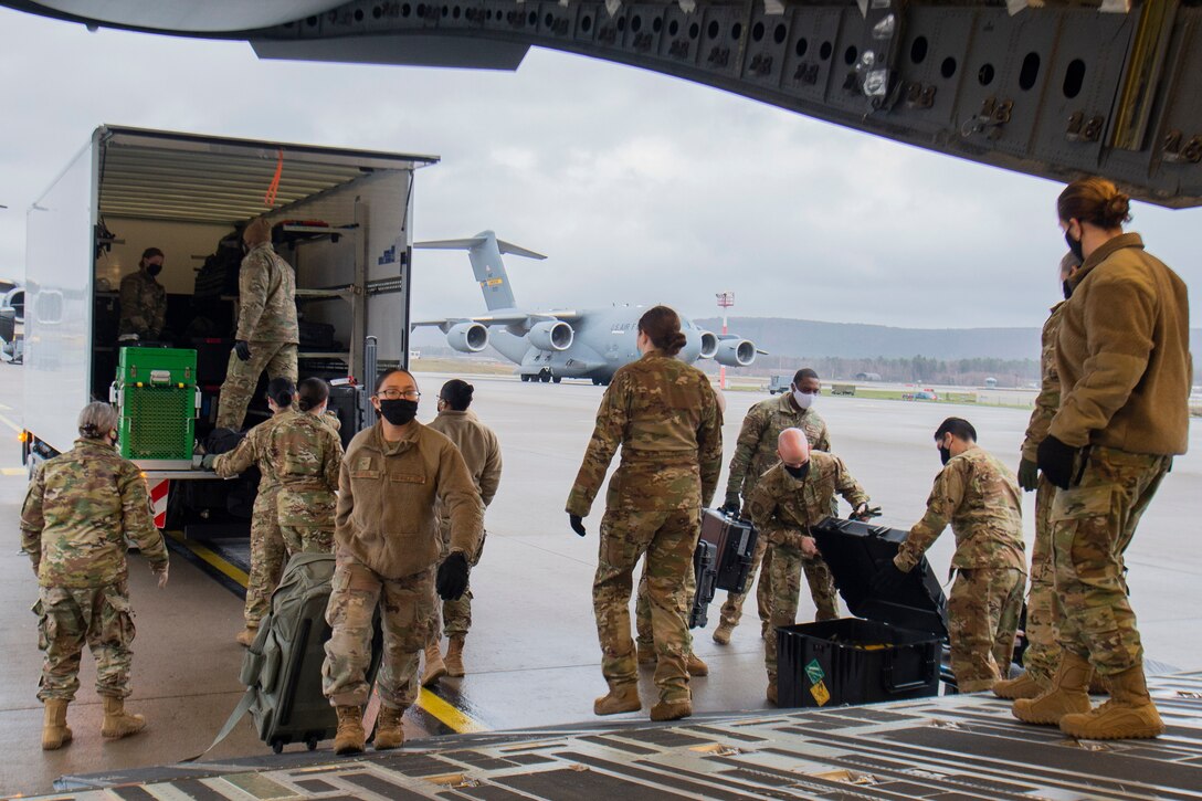 U.S. Air Force Airmen assigned to the 10th Expeditionary Aeromedical Evacuation Flight disembark from a bus and enter a C-17 Globemaster III aircraft for a training at Ramstein Air Base, Germany, Jan. 26, 2021.