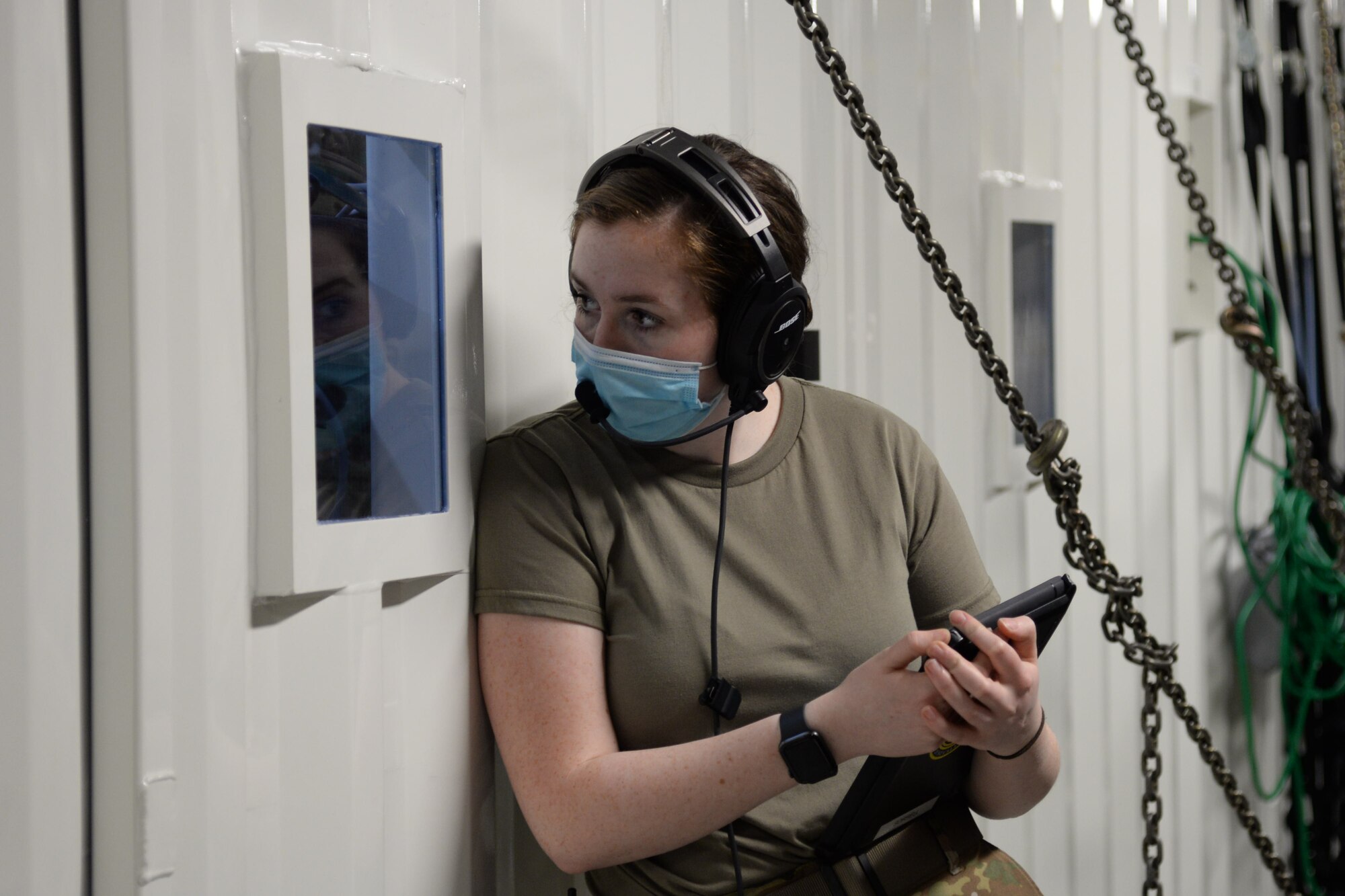 U.S. Air Force Airman 1st Class Fiona Kirnan, 10th Expeditionary Aeromedical Evacuation Flight medical technician, looks through a window of a Negatively Pressurized Conex during a training at Ramstein Air Base, Germany, Jan. 30, 2021