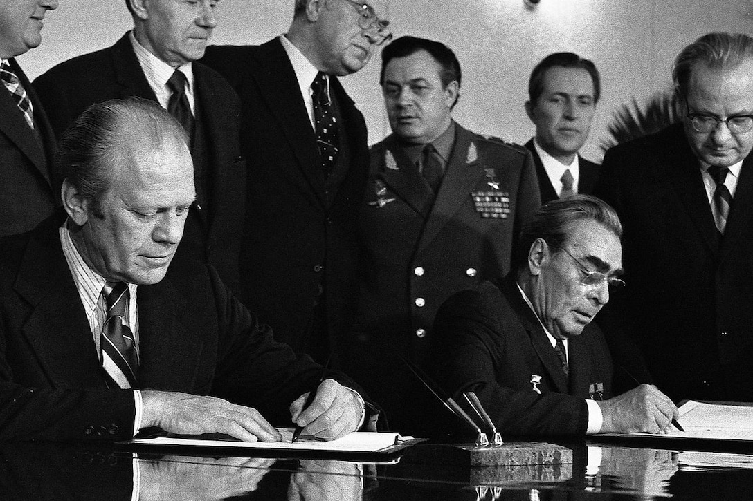 Men sign a treaty.