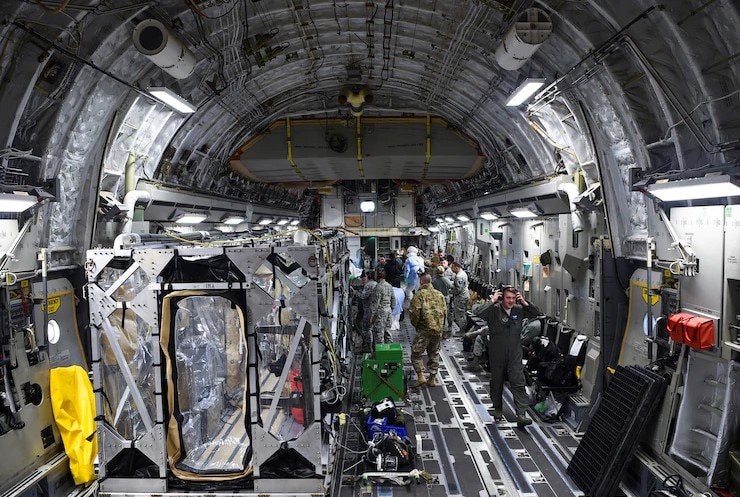 A U.S. Air Force C-17 Globemaster III is prepped to transport a transportation isolation system March 6, 2019, during a training exercise that allows Airmen to practice the most effective and safest form of transportation for patients and their medical professionals.