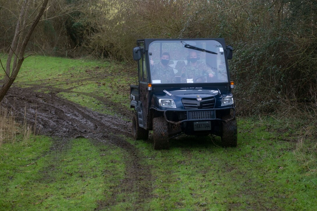 U.S. Air Force Col. Kurt Wendt, left, 501st Combat Support Wing commander, and Lt. Col. Joseph Knothe, right, 420th Air Base Squadron commander, drive an ATV around the base perimeter of Royal Air Force Fairford, England, Feb. 3, 2021. The 501st CSW command team visited the 420th Expeditionary Air Base Squadron team, deployed from Spangdahlem Air Base, to recognize their efforts in keeping the flight line running during inclement weather. (U.S. Air Force photo by Senior Airman Jennifer Zima)