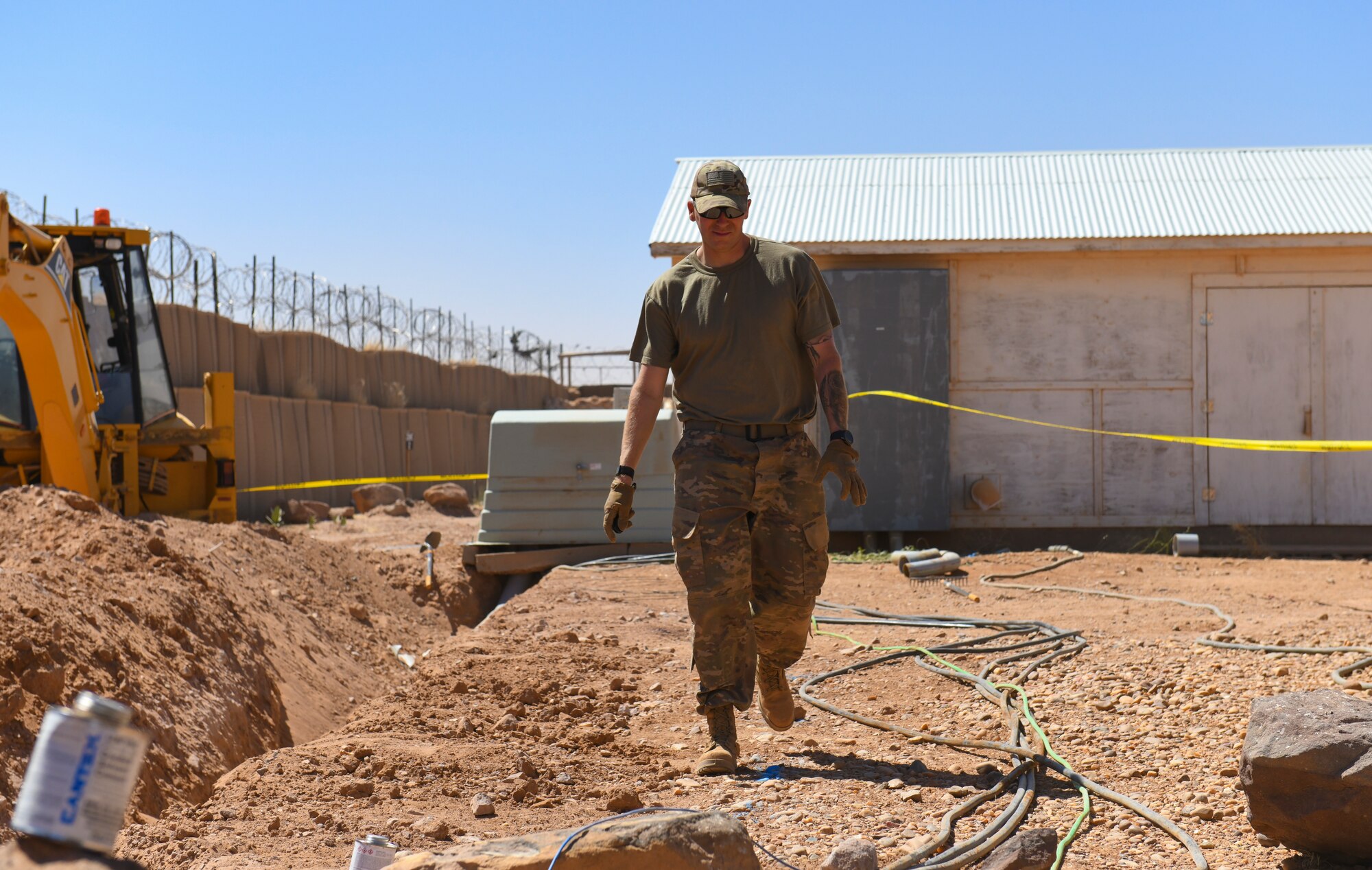 U.S. Air Force Tech. Sgt. Jessie Correia, 724th Expeditionary Air Base Squadron civil engineer electrical systems supervisor, surveys the site where old polyvinyl chloride conduit and wiring will be replaced at Nigerien Air Base 201, Agadez, Niger, Feb. 4, 2021. The electrical systems team deployed to Air Base 201 is responsible for all electrical power on base. (U.S. Air Force photo by Senior Airman Gabrielle Winn)