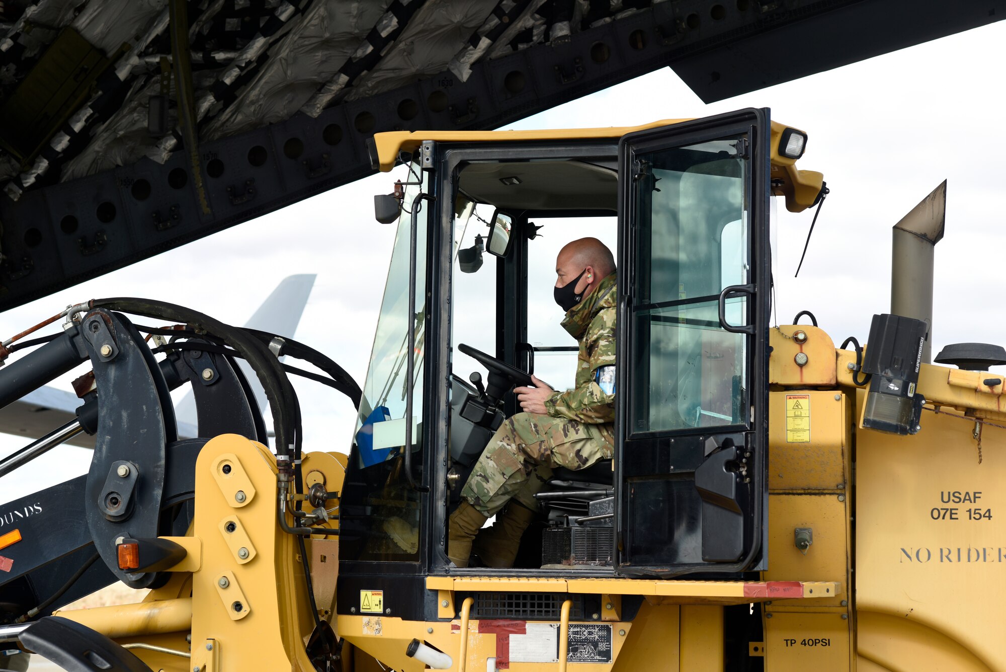 U.S. Air Force Air Transportation Specialist, Staff. Sgt. Jason Moore, 145th Logistics Readiness Squadron, loads a large item aboard a C-17 Globemaster III aircraft during a Cargo Deployment Function (CDF) exercise held at the North Carolina Air National Guard Base, Charlotte Douglas International Airport, Feb. 7, 2021. A CDF is similar to a personnel deployment line where you have a station to assemble items, check them for quality and to make sure they can safely be loaded onto an aircraft. Once the items are cleared to be loaded onto an aircraft, they reach the final phase of the CDF.