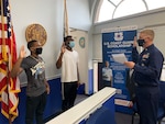 Chief Petty Officer Walter Morey, the Recruiter In Charge of Recruiting Office Hampton Roads, Va., swears in two new recruits under the Pandemic Displaced Recruit Program on Tuesday, Jan. 5, 2021.