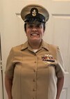 Personnel Specialist Chief Veronica Guadalupe Foley poses for a photo while standing at attention in her CPO uniform.