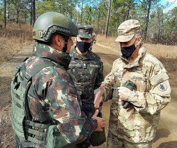 Maj. Gen. Daniel R. Walrath, right, U.S. Army South commanding general, greets a Brazilian Army soldier taking part in the bilateral training exercise at the Joint Readiness Training Center at Fort Polk, Louisiana, Feb. 2, as Lt. Gen. Marcos de Sá Affonso da Costa, chief of training, Land Forces Training Command, Exército Brasileiro, looks on.